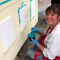 woman painting parade float